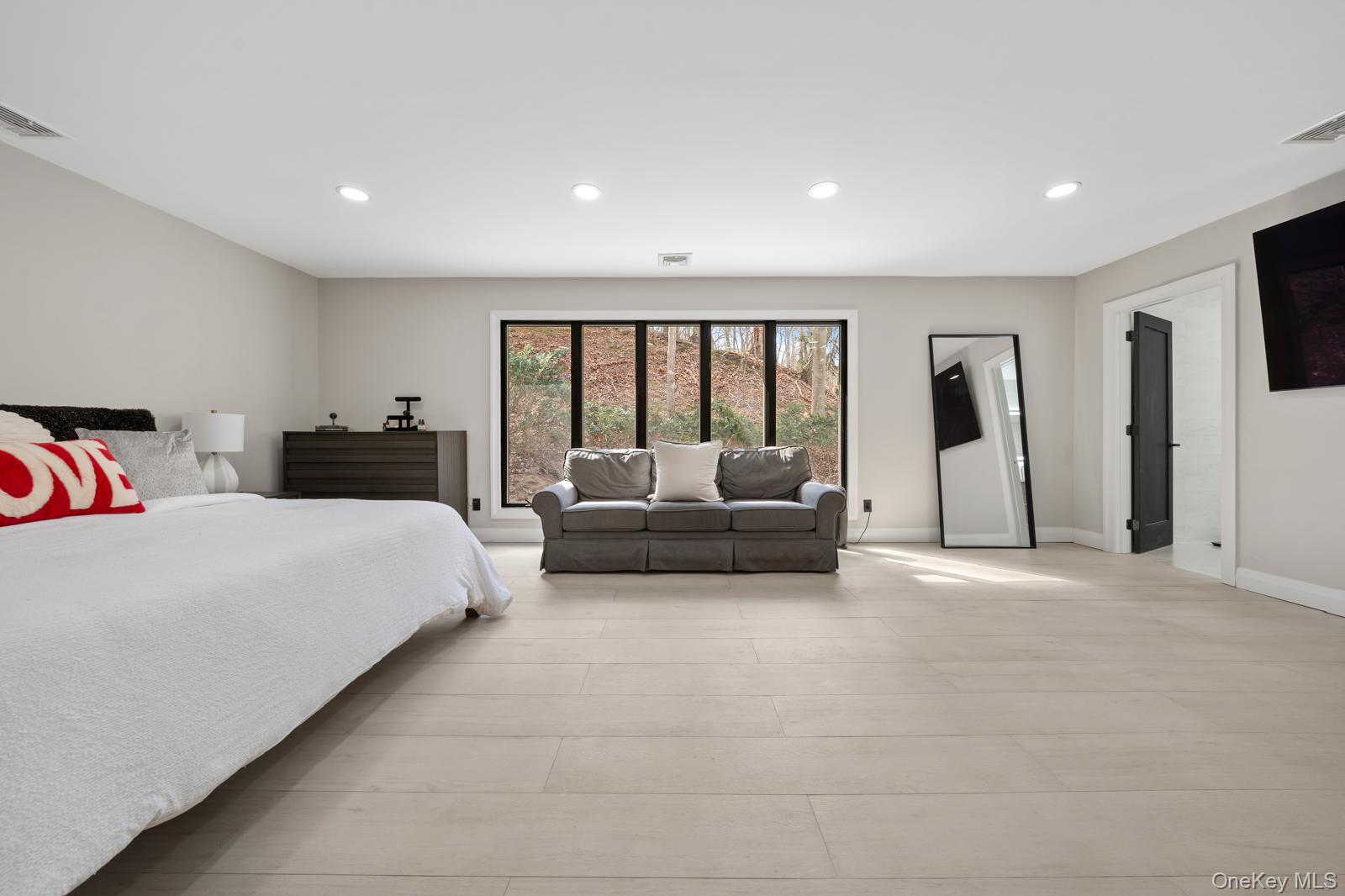 111 Mill River Road Oyster Bay, NY 11771 - Photo 20 of 48 a bedroom with furniture and a large window