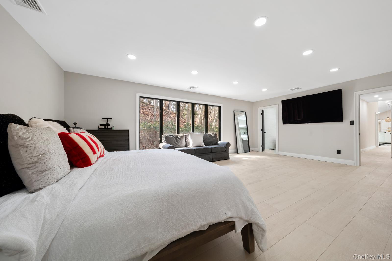 111 Mill River Road Oyster Bay, NY 11771 - Photo 22 of 48 a bedroom with a large bed and a flat tv screen