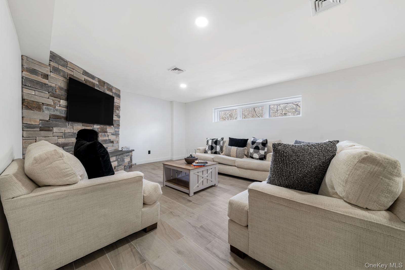 111 Mill River Road Oyster Bay, NY 11771 - Photo 28 of 48 a living room with furniture wooden floor and a flat screen tv
