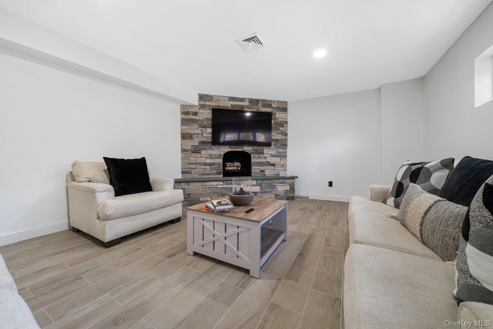 111 Mill River Road Oyster Bay, NY 11771 - Photo 29 of 48 a living room with furniture and a fireplace