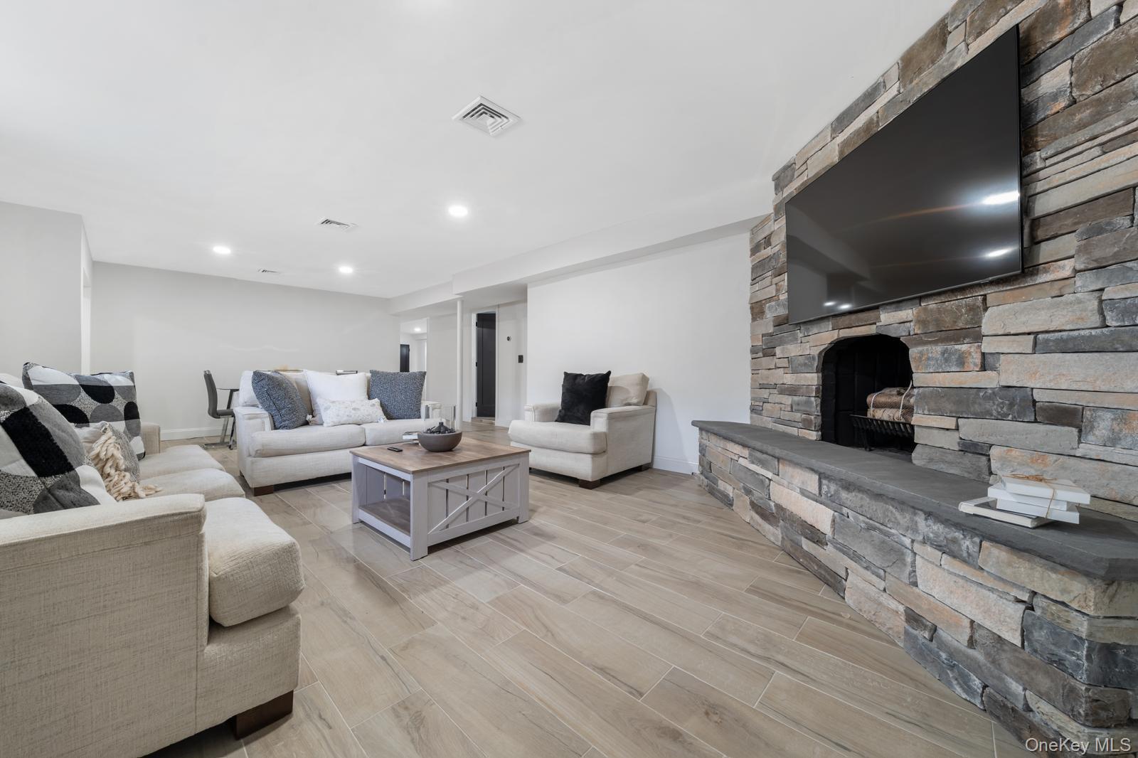 111 Mill River Road Oyster Bay, NY 11771 - Photo 30 of 48 a living room with furniture and a fireplace