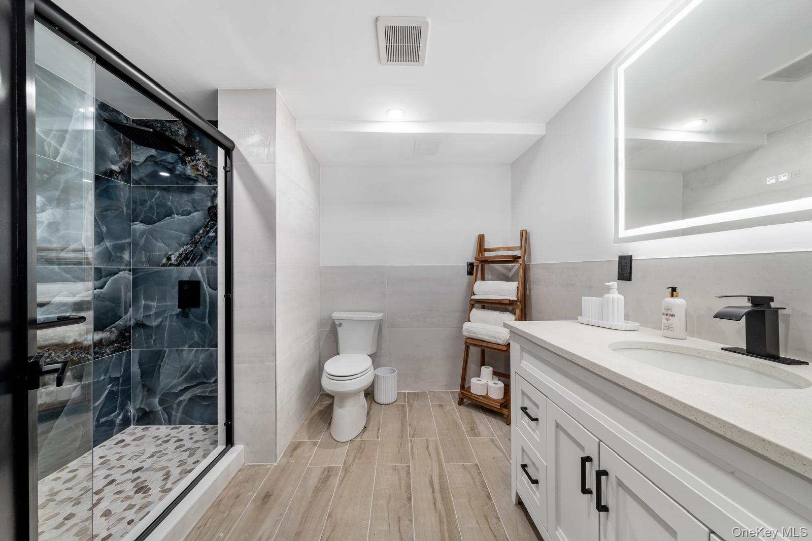 111 Mill River Road Oyster Bay, NY 11771 - Photo 32 of 48 a bathroom with a sink a toilet and shower