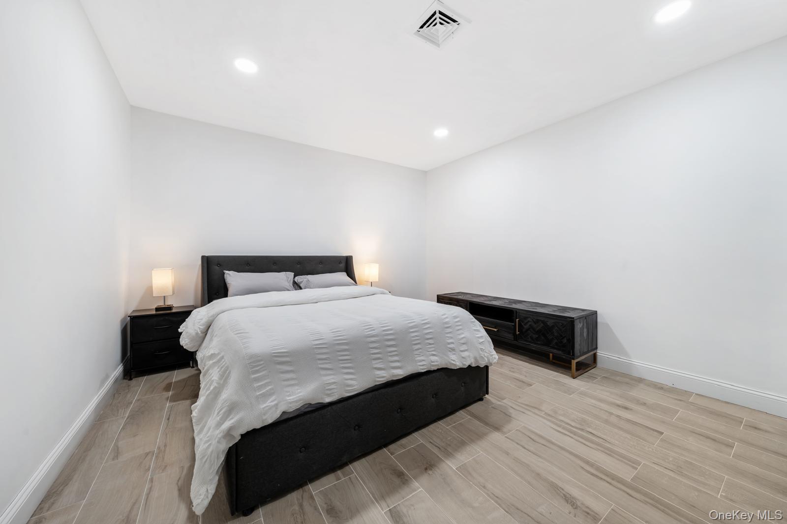 111 Mill River Road Oyster Bay, NY 11771 - Photo 35 of 48 a bedroom with a bed and wooden floor