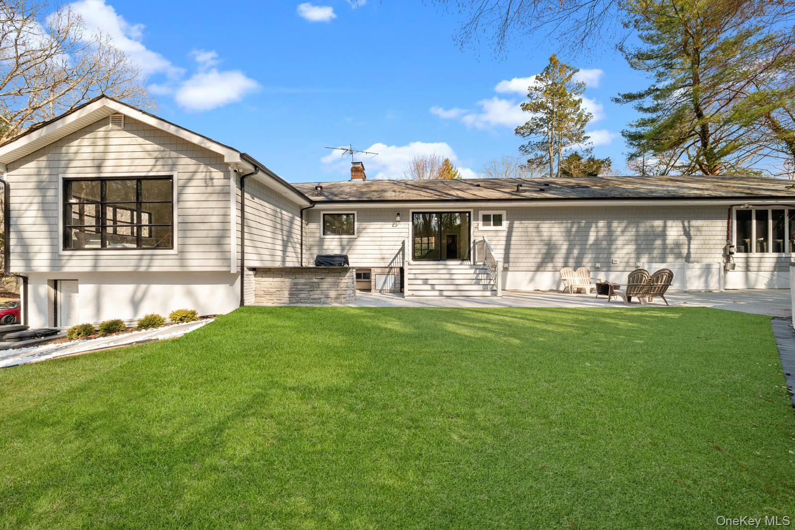 111 Mill River Road Oyster Bay, NY 11771 - Photo 38 of 48 a front view of house with yard and outdoor seating
