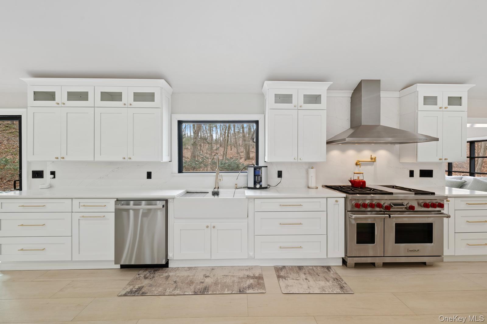 111 Mill River Road Oyster Bay, NY 11771 - Photo 9 of 48 a kitchen with stainless steel appliances granite countertop a stove and white cabinets