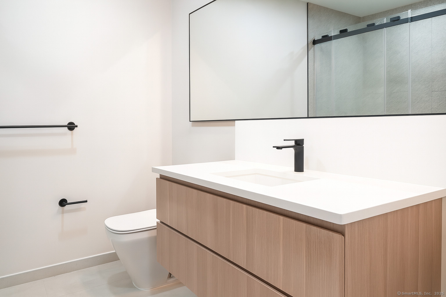 267 Main Street, Unit 302 New Britain, CT 06051 - Photo 2 of 9 a bathroom with a sink a toilet a mirror and shower