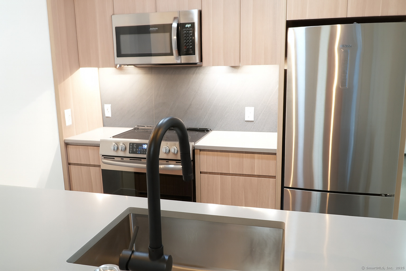 267 Main Street, Unit 302 New Britain, CT 06051 - Photo 4 of 9 a kitchen with stainless steel appliances a refrigerator and a stove top oven