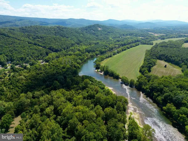an aerial view of a house with garden space and lake view