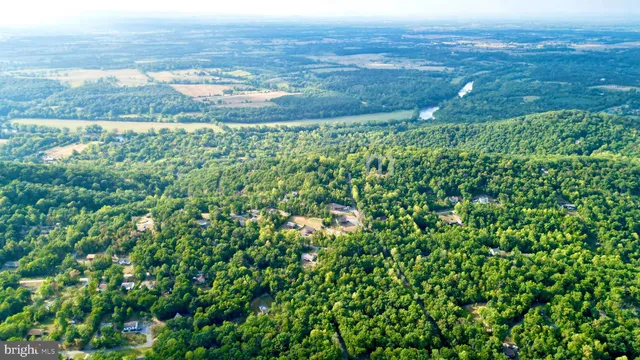 a backyard of a house with lots of green space and lake view