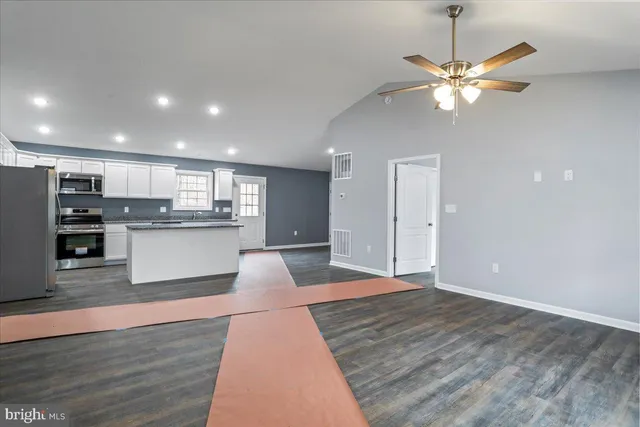 a view of kitchen with sink and wooden floor