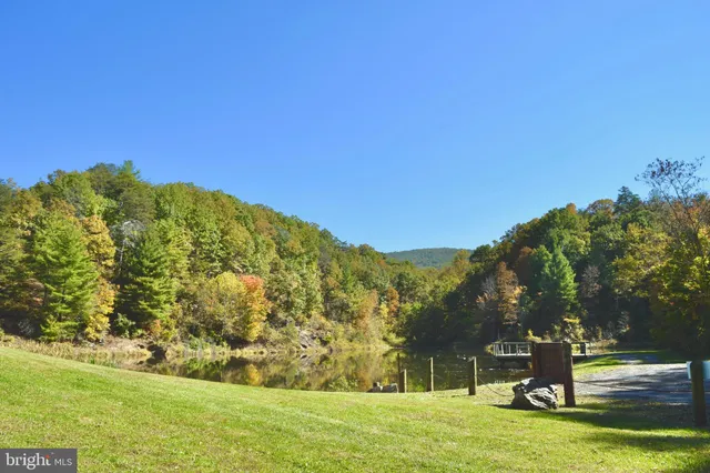 a large kitchen with stainless steel appliances granite countertop a stove a sink and a microwave