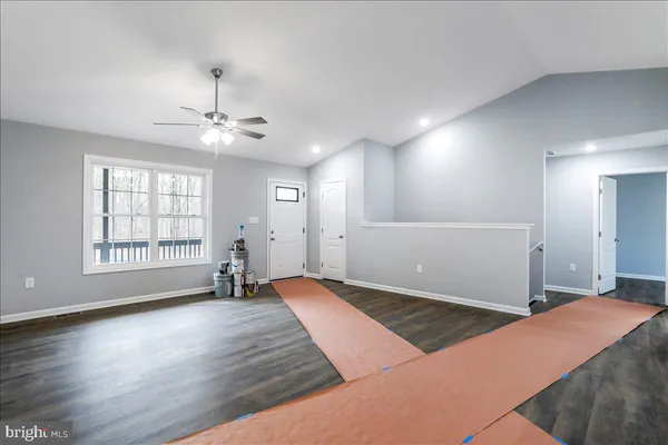 a large kitchen with stainless steel appliances granite countertop a sink and cabinets