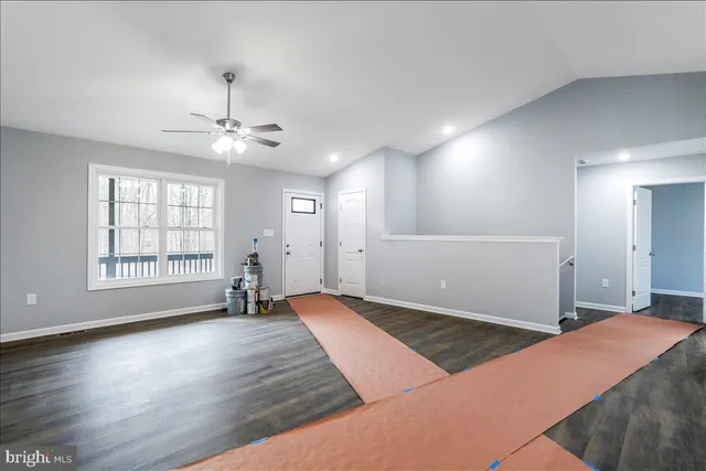 a large kitchen with stainless steel appliances granite countertop a sink and cabinets