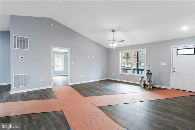 a kitchen with stainless steel appliances granite countertop a sink stove and wooden floor