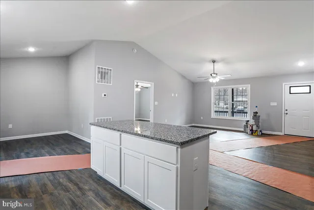 a kitchen with stainless steel appliances granite countertop a sink stove and cabinets