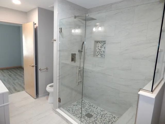 a bathroom with a shower a toilet and sink