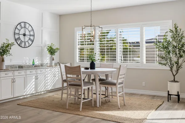 a dining room filled chandelier and fireplace