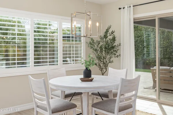 a dining room with furniture window and wooden floor