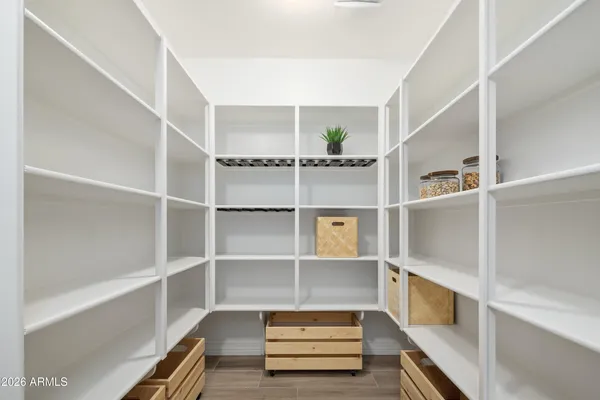 a view of walk in closet with empty racks