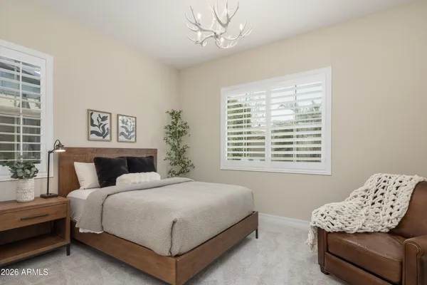 a bedroom with a bed couch and window