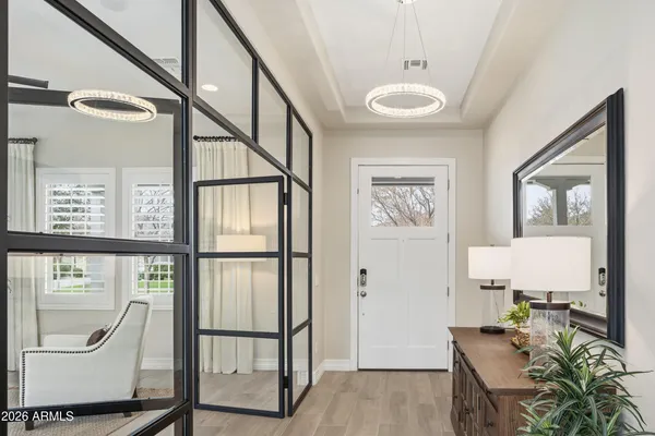 a view of an entryway with wooden floor and door