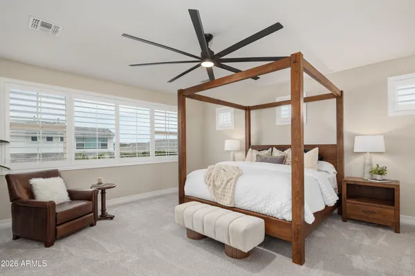 a bedroom with bed couch and window