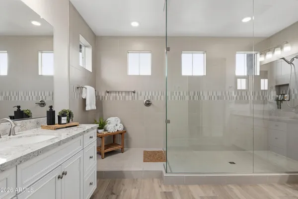 a bathroom with a shower sink and mirror