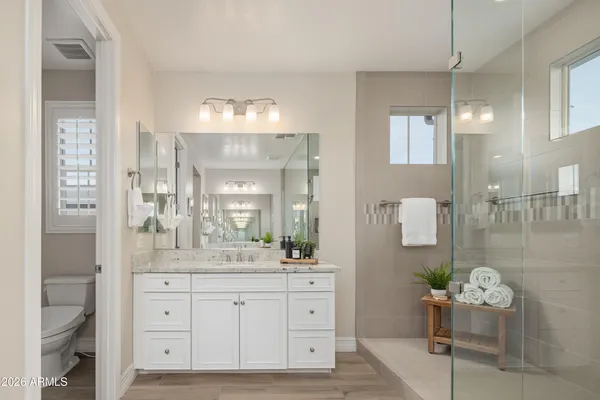 a bathroom with a sink double vanity and a mirror