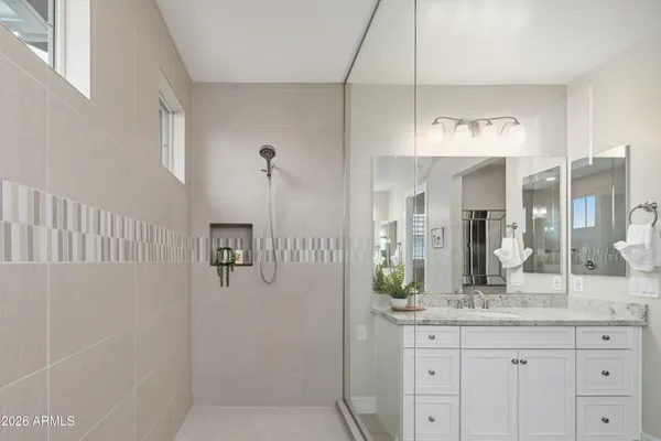 a bathroom with a granite countertop sink and a mirror