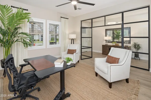 a living room with furniture and a potted plant