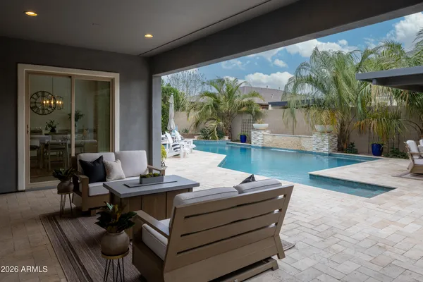 a view of a white house with a large tree