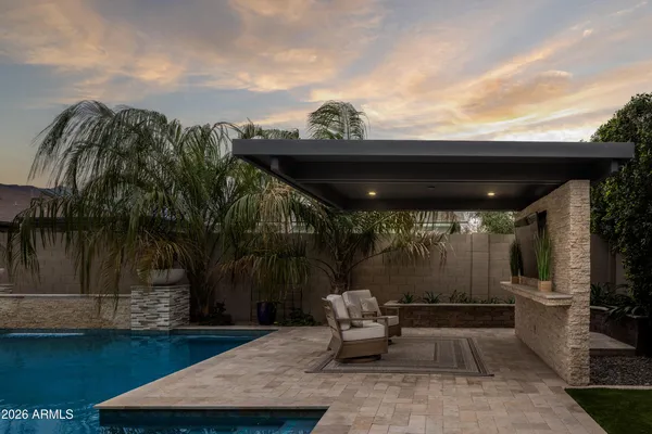 a view of a house with backyard and sitting area