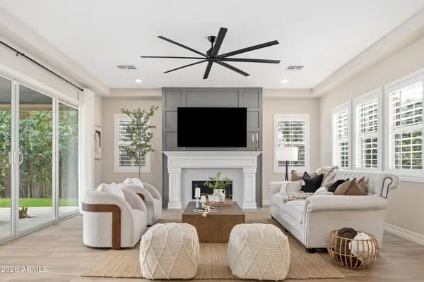 a living room with furniture fireplace and window