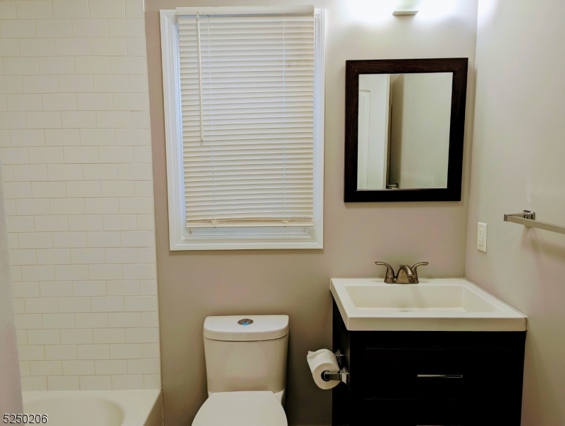 116 Maple Avenue, Unit 1 Montclair, NJ 07042 - Photo 4 of 7 a bathroom with a toilet sink and mirror