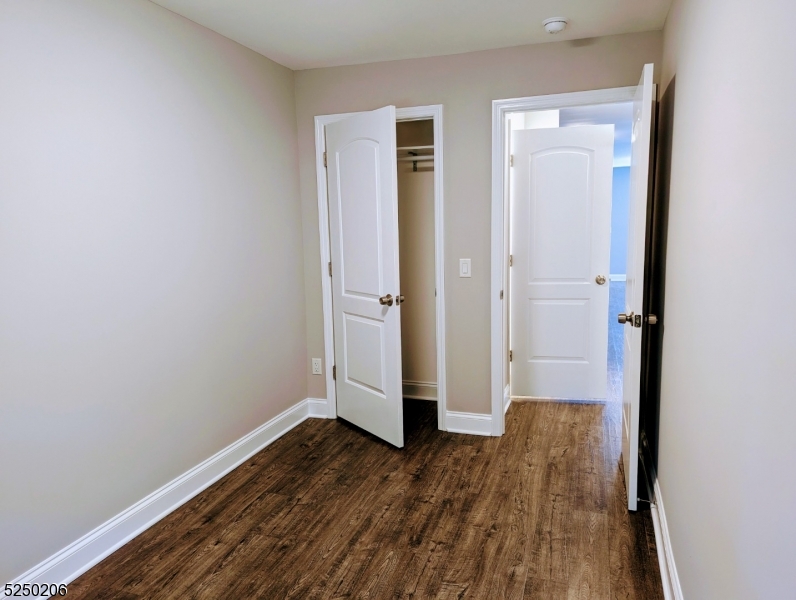 116 Maple Avenue, Unit 1 Montclair, NJ 07042 - Photo 5 of 7 an empty room with wooden floor and entrance