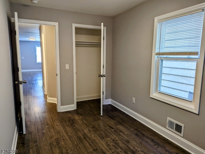 116 Maple Avenue, Unit 1 Montclair, NJ 07042 - Photo 6 of 7 a view of an empty room with wooden floor and a window