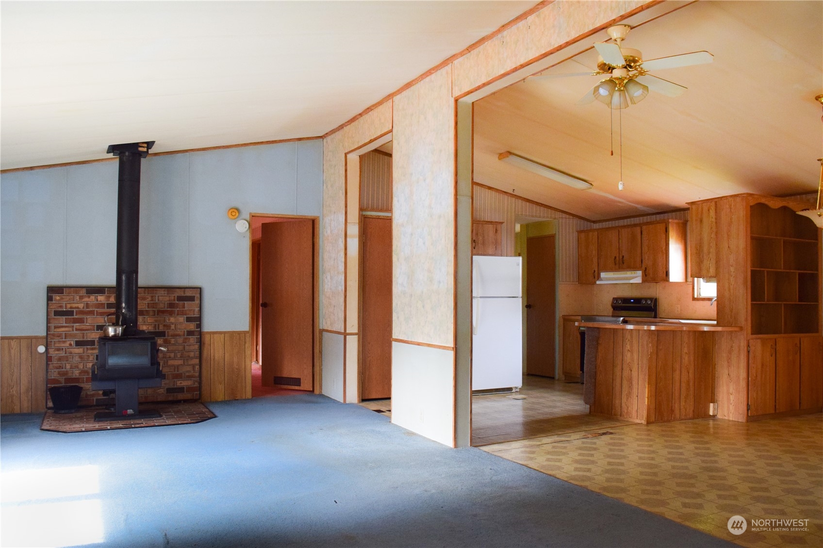 7701 Hardeson Road, Unit 13 Everett, WA 98203 - Photo 4 of 22 a view of a kitchen with a sink and a refrigerator