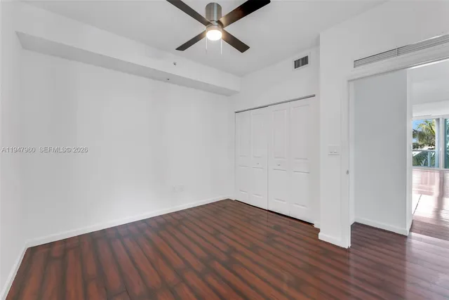 a bedroom with a bed and a ceiling fan