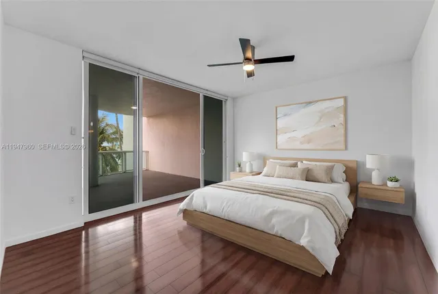 a view of empty room with wooden floor and ceiling fan