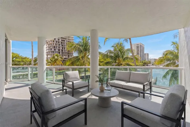 a balcony with table and chairs