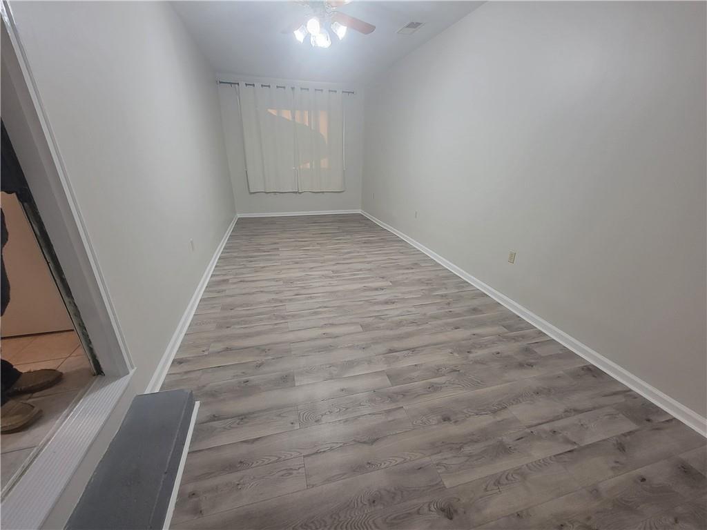1326 Lori Court Conley, GA 30288 - Photo 15 of 15 an empty room with wooden floor and entryway