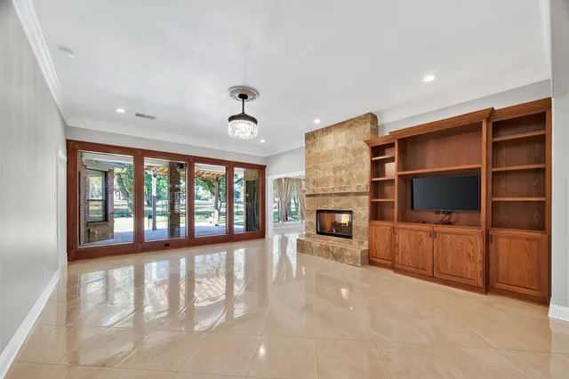 a view of a livingroom with fireplace and window