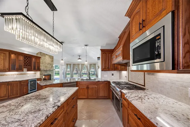 a kitchen with stainless steel appliances granite countertop a stove and a refrigerator