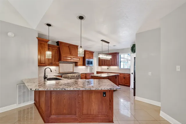 a kitchen with a sink a counter top space cabinets and stainless steel appliances