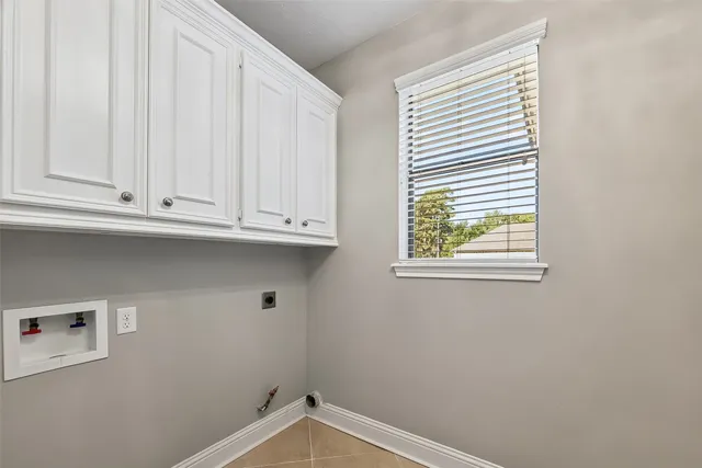 a kitchen with granite countertop a sink a counter space and cabinets