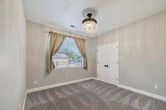a bathroom with a granite countertop double vanity sink and a mirror