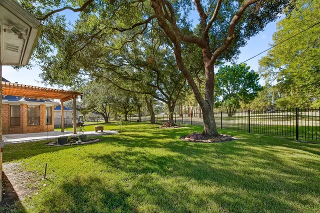 a view of a house with a yard and sitting area