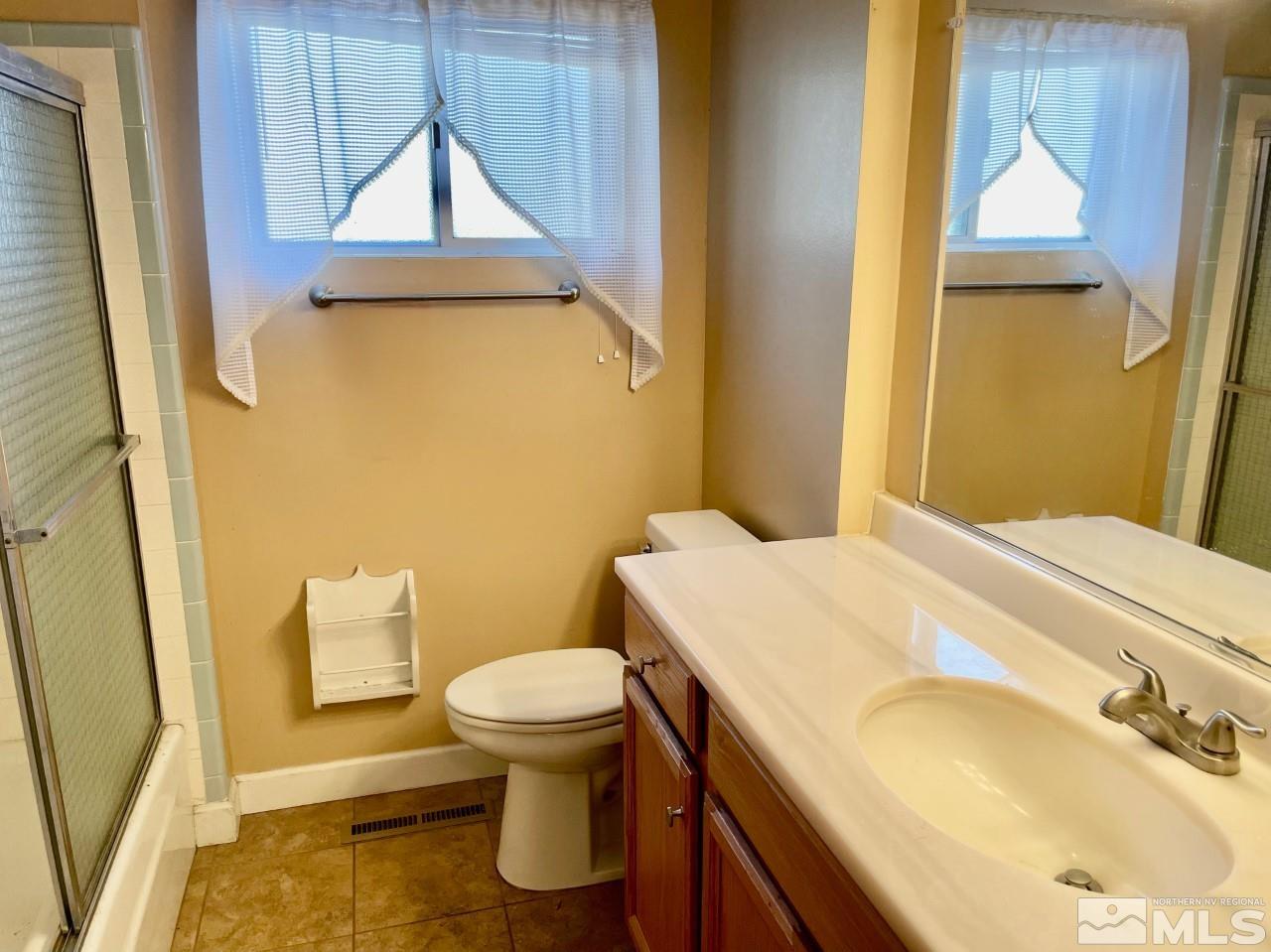 3280 Idlewild Drive Reno, NV 89509 - Photo 13 of 22 a bathroom with a sink and a mirror