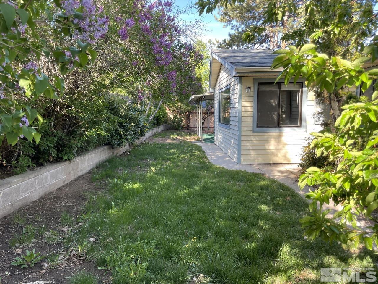 3280 Idlewild Drive Reno, NV 89509 - Photo 19 of 22 a front view of a house with a yard and potted plants