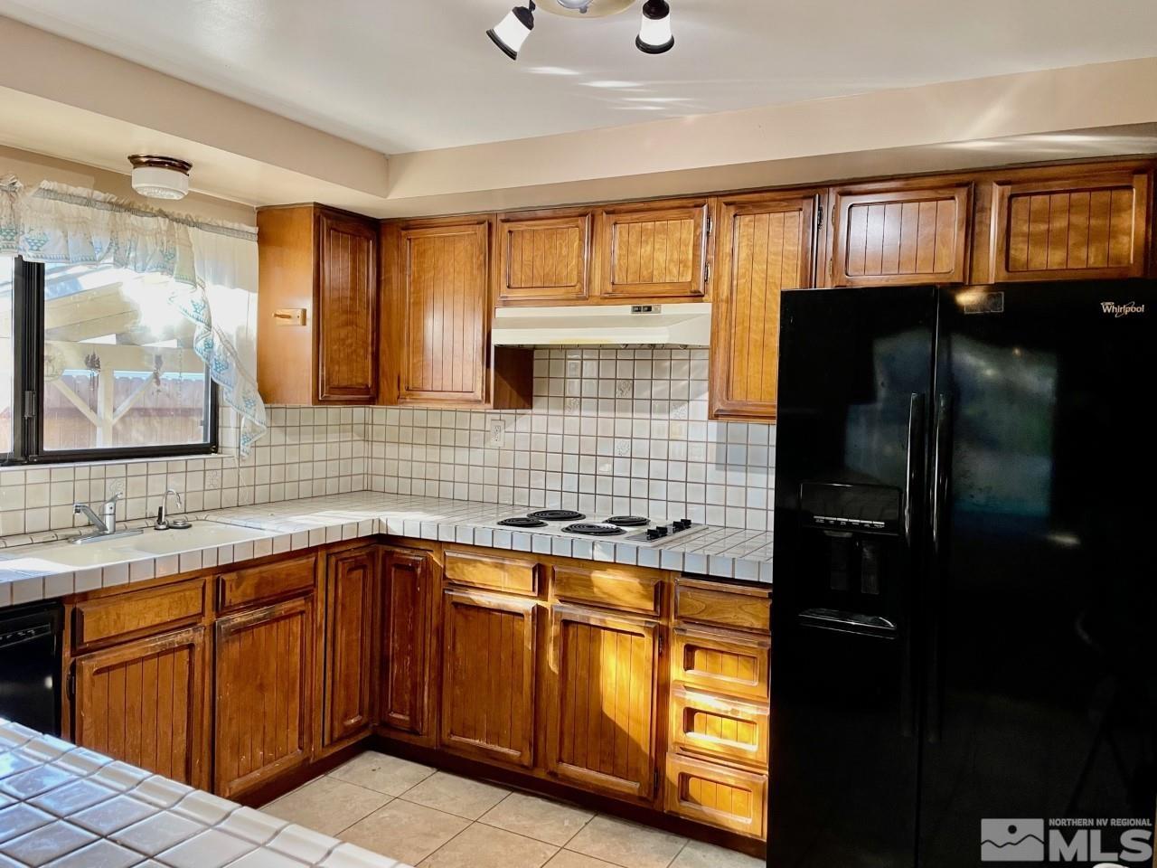 3280 Idlewild Drive Reno, NV 89509 - Photo 7 of 22 a kitchen with stainless steel appliances granite countertop a refrigerator and a sink